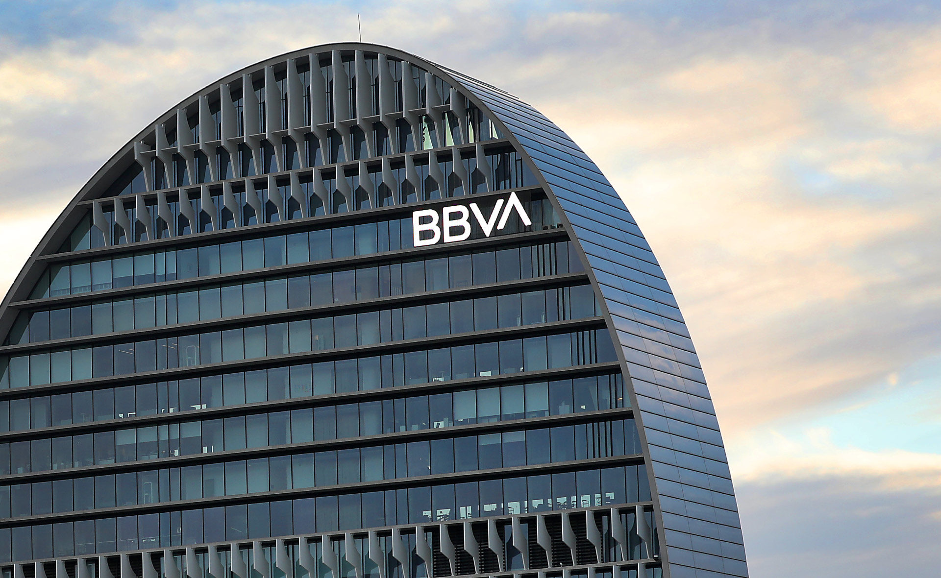 Outside BBVA office with a sunset in the background
