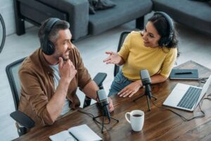 A men and a women at a modern podcasting studio