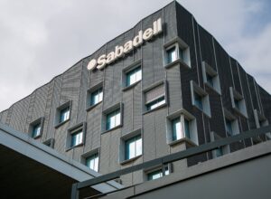 The outside of a Sabadell office with the logo on the wall