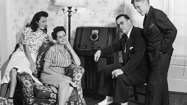 Family gathered around the radio (20th century)