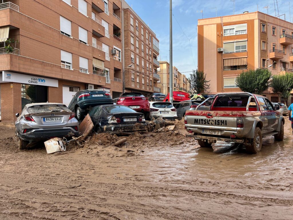 Cars piled in the street after Valencia's flash floods