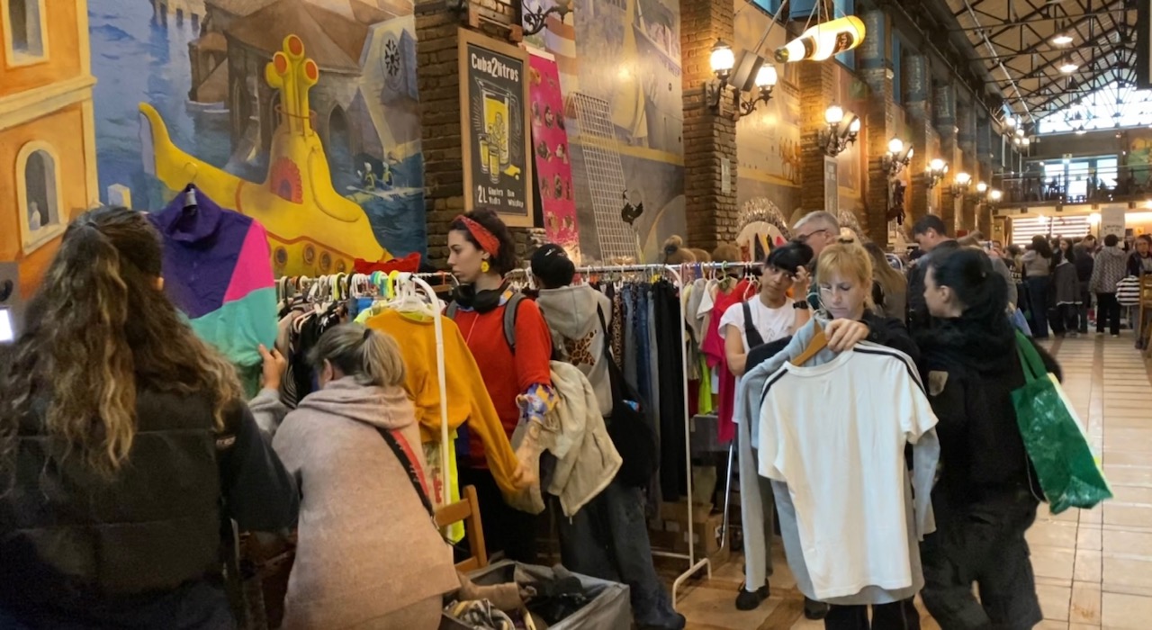 young and old people in a second hand pop-up with clothes